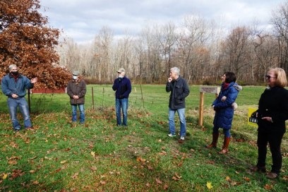 Board members and family members discuss the project during the property dedication ceremony