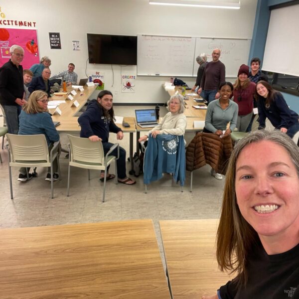 Board president Amanda Thompson in the foreground takes a picture during the first meeting of the new board of directors